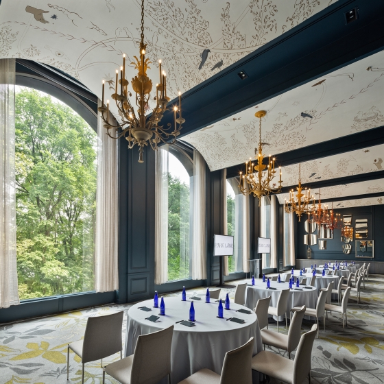 An elegant meeting room with tables set up to watch a presentation.