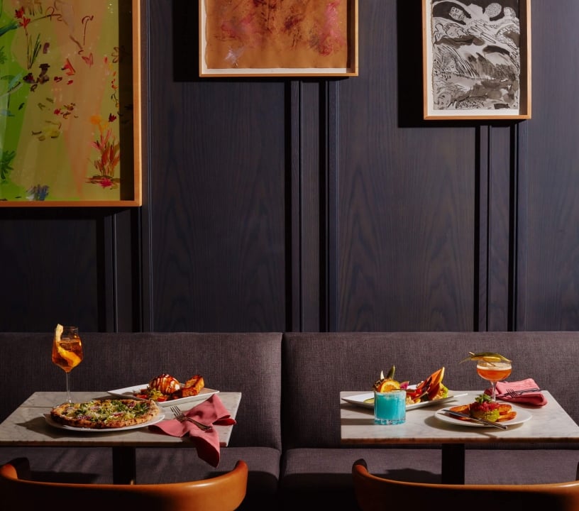 Two tables with assorted dishes on them.