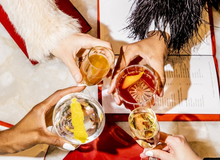 shared cocktails over a menu