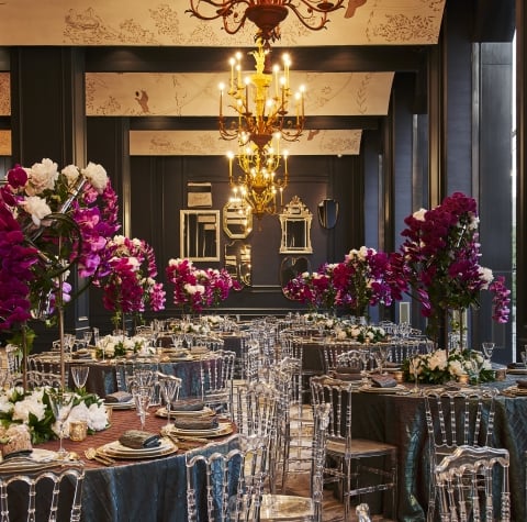 a formal dining room with tables set for a meal